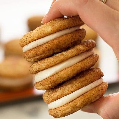 Rich and delicious eggnog buttercream frosting snuggled inside of Snickerdoodle Sandwich Cookies makes for a perfect holiday treat! Recipe includes nutritional information. From BakingMischief.com