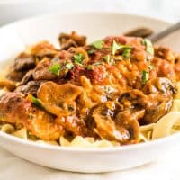 This Easy Chicken Cacciatore is boneless, skinless chicken thighs and mushrooms simmered in a rich tomato sauce and served over a bed of egg noodles for a fabulous weeknight meal.