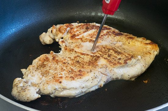 Temperature of chicken breast being taken.