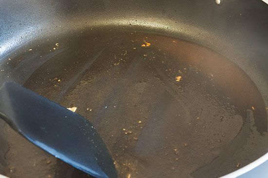 Pan being deglazed after cooking chicken breasts.