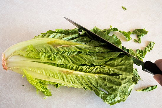 How to cut romaine lettuce for salads the fastest and easiest way possible. From BakingMischief.com