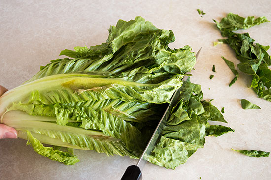 How to cut romaine lettuce for salads the fastest and easiest way possible. From BakingMischief.com