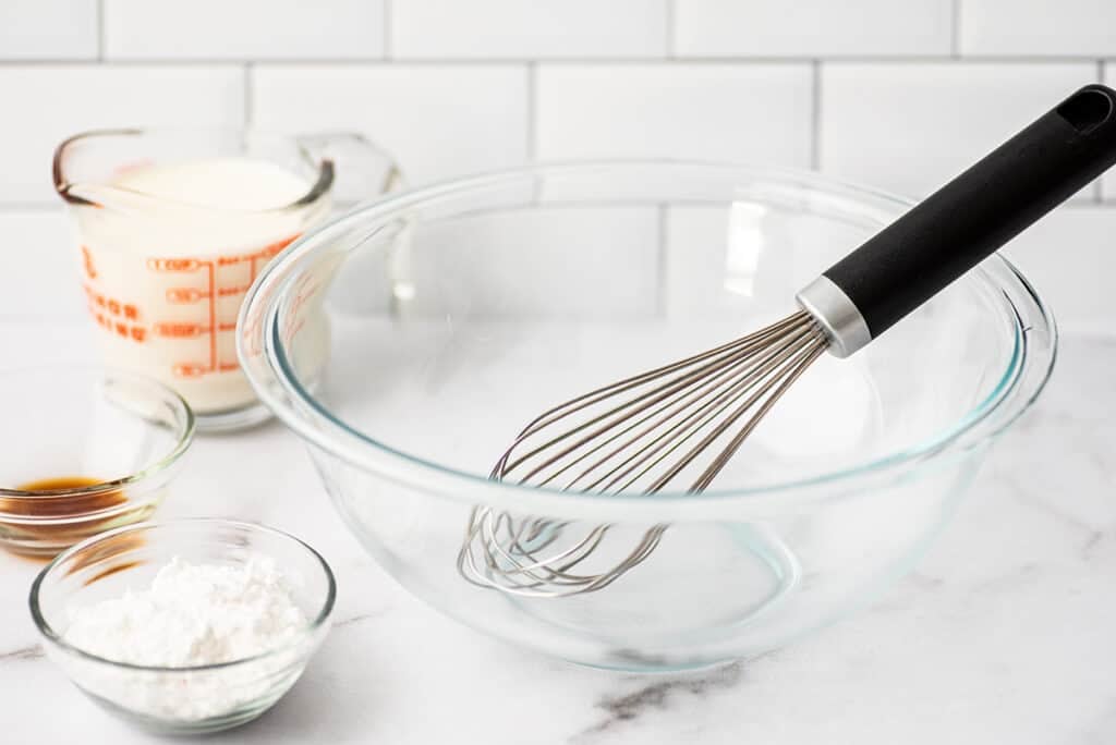 Glass bowl with a whisk inside.
