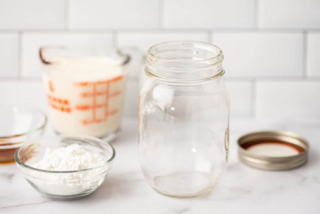 Mason jar for making whipped cream on a counter.
