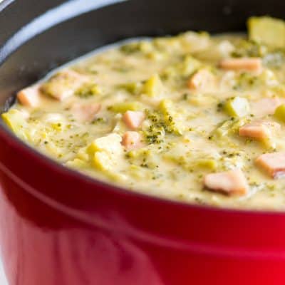 Cheesy Broccoli Chowder With Ham in a red pot.