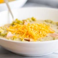 Broccoli chowder in a white bowl.