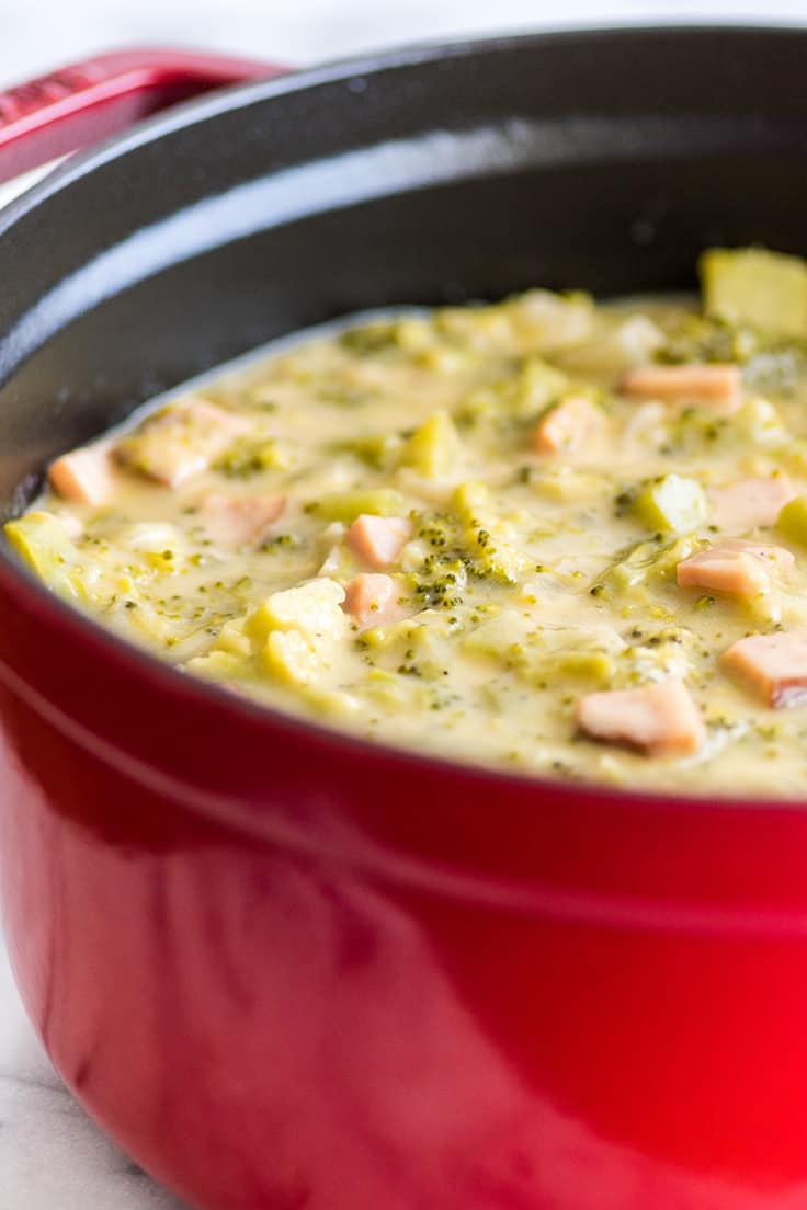 Cheesy Broccoli Chowder With Ham in a red pot.