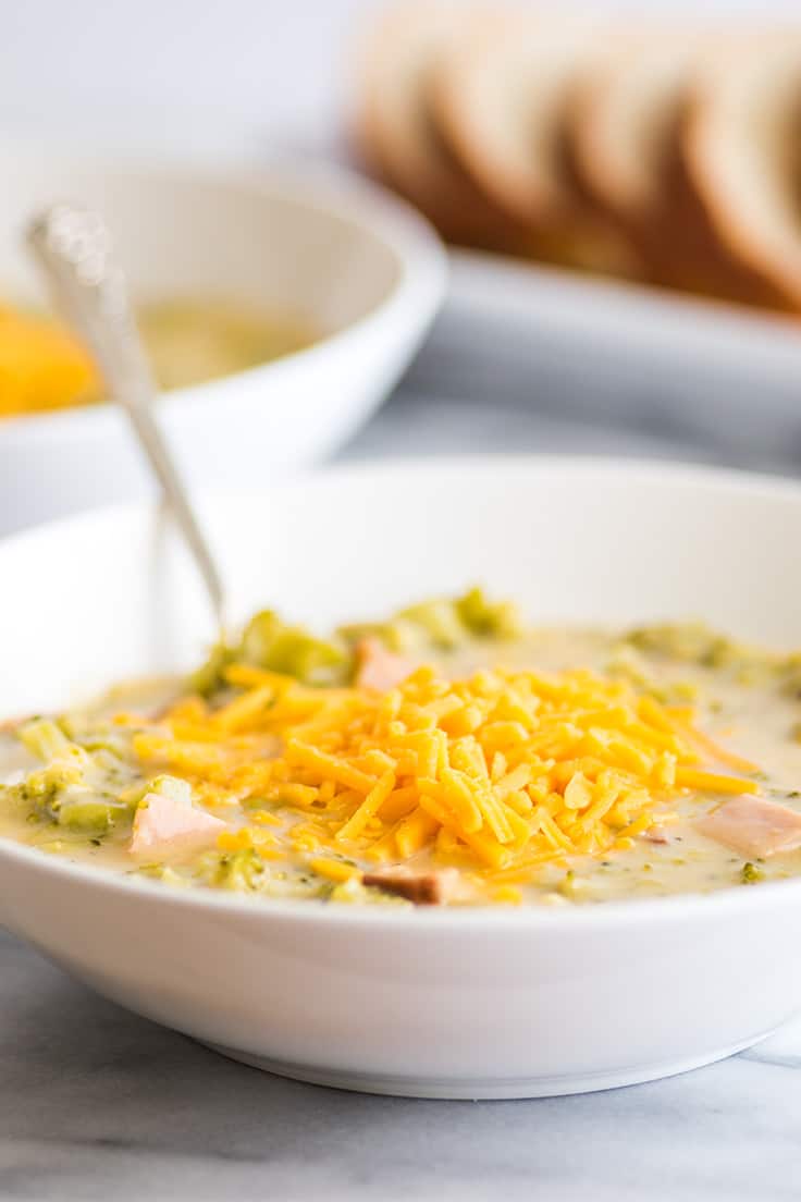 Easy Cheesy Broccoli Chowder With Ham in a white bowl.