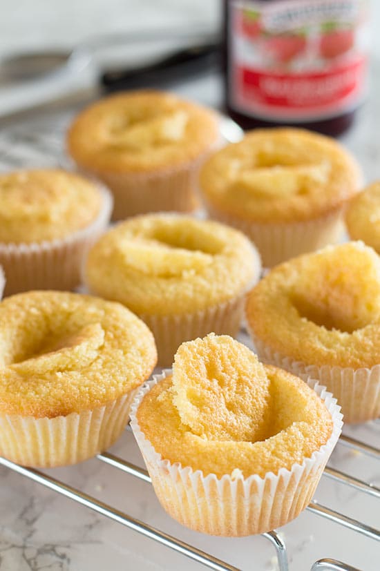 Victoria Sponge Cupcakes - Adorable light and airy sponge cupcakes filled with raspberry jam and topped with buttercream frosting. Recipe includes nutritional information and small-batch instructions. From BakingMischief.com