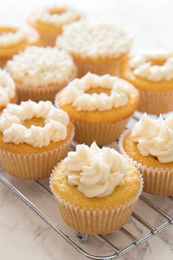 Adorable light and airy Victoria Sponge Cupcakes filled with raspberry jam and topped with buttercream frosting.