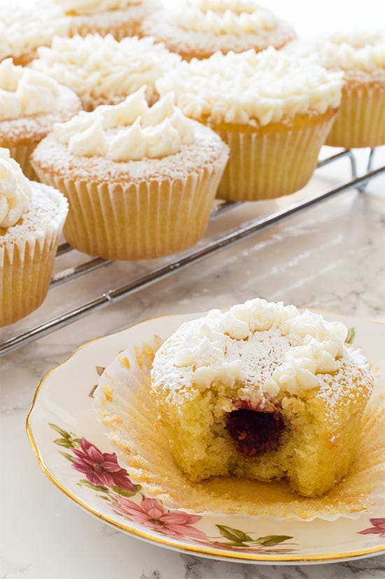 Victoria Sponge Cupcakes - Adorable light and airy sponge cupcakes filled with raspberry jam and topped with buttercream frosting. Recipe includes nutritional information and small-batch instructions. From BakingMischief.com