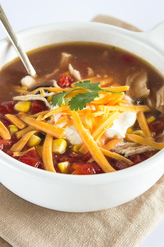 World's Easiest Chicken Taco Soup - A healthy and delicious chicken soup for quick weeknight dinners. So good, you'd never guess it takes fewer than 10 minutes to make. From BakingMischief.com