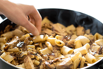 Lightened Up Copycat Carmela's Chicken - Chicken, mushrooms, and delicious caramelized onions cooked up in a wine and cream sauce and served over rigatoni. A lightened up version of the Macaroni Grill favorite. Recipe includes nutritional information, make-ahead and low-yield instructions. From BakingMischief.com