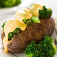 Baked potato topped with broccoli and cheddar cheese sauce.