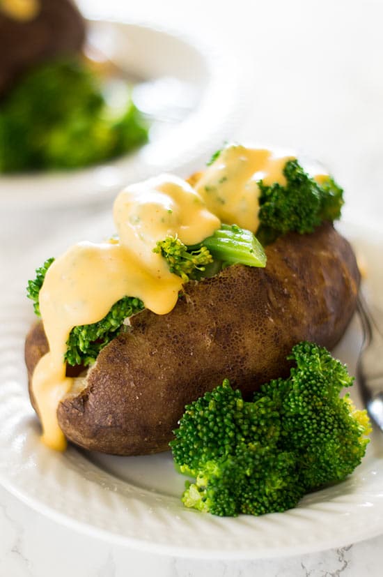 Baked potato topped with broccoli and cheddar cheese sauce.