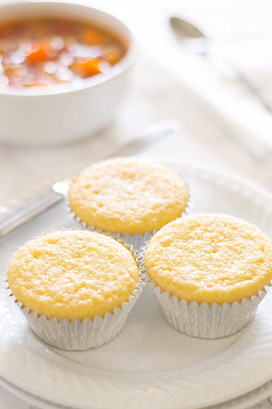 Corn bread muffins on a white plate.