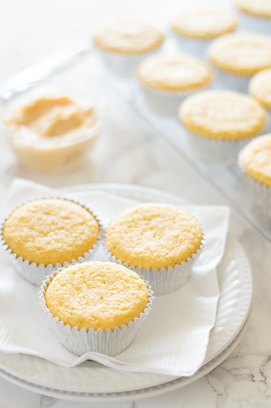 Three cornbread muffins on a plate.