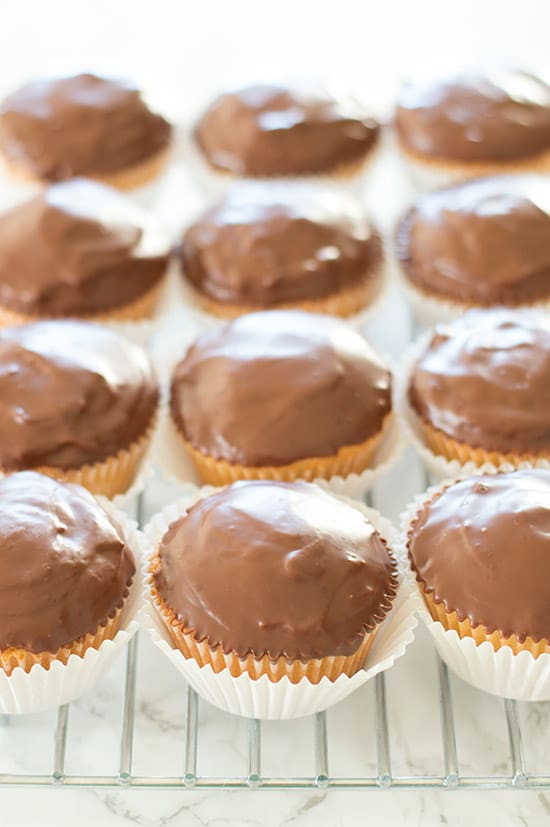 Tagalong Cupcakes are pound cake covered in peanut butter buttercream and dipped in chocolate. A perfect cupcake version of the Girl Scouts' best cookie. From BakingMischief.com
