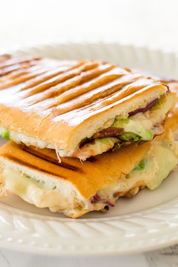 My favorite quick weeknight panini with chipotle aioli, crunchy red onions, sliced turkey, melty cheese, and avocado. Recipe includes nutritional information. From BakingMischief.com