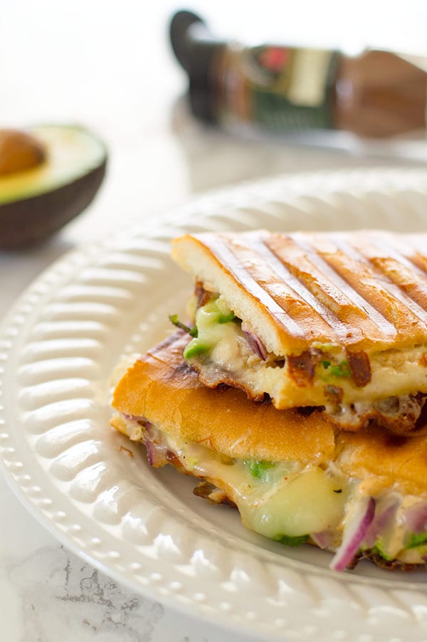 My favorite quick weeknight panini with chipotle aioli, crunchy red onions, sliced turkey, melty cheese, and avocado. Recipe includes nutritional information. From BakingMischief.com