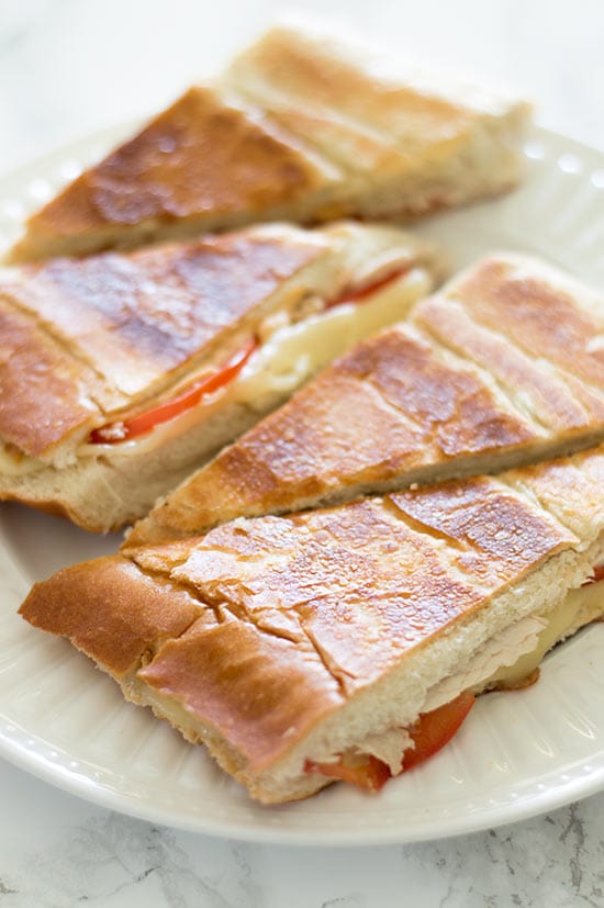 Perfectly cooked panini, crunchy and toasted on the outside, warm, gooey, and cheesy on the inside, all without using a panini press! Recipe includes nutritional information. From BakingMischief.com