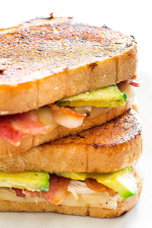 A grown up grilled cheese sandwich loaded with bacon, avocado, chicken, and pepper jack cheese. Recipe includes nutritional information. From BakingMischief.com