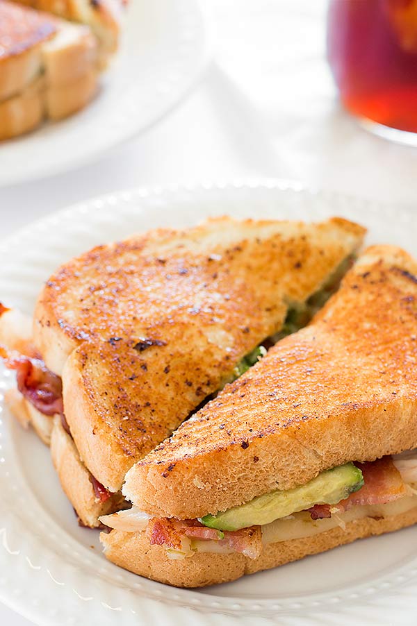 A grown up grilled cheese sandwich loaded with bacon, avocado, chicken, and pepper jack cheese. Recipe includes nutritional information. From BakingMischief.com