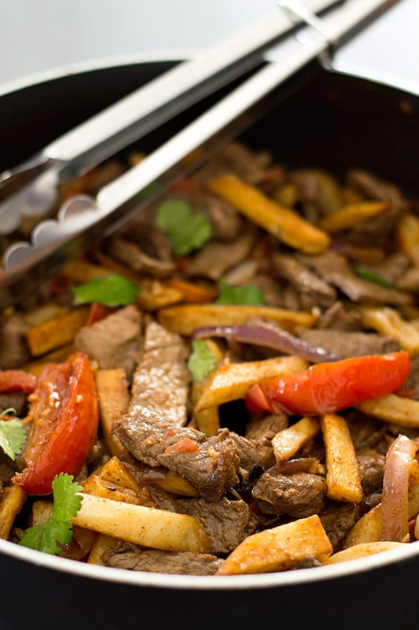 Lomo Saltado is tender stir-fried beef sirloin, red onions, and tomatoes served with baked french fries and white rice. Carb lovers, you have to try this one!