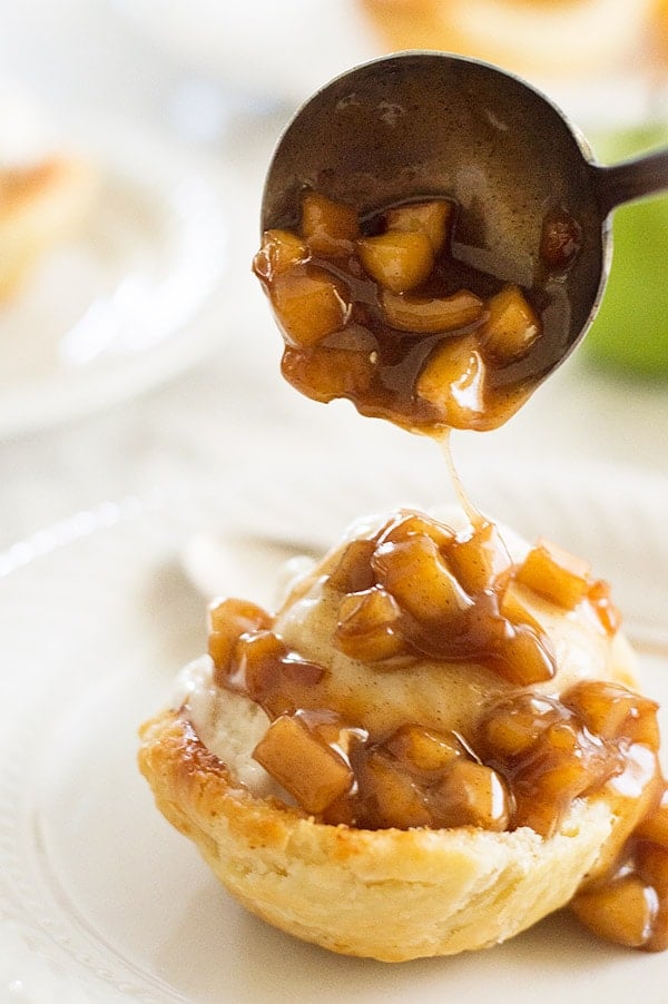 Apple pie in sundae form! Tart Granny Smith apples cooked with brown sugar and cinnamon and dowsed in caramel sauce. Served over vanilla ice cream in a flaky homemade (easy!) buttermilk pie crust shell. Recipe includes nutritional information. From BakingMischief.com