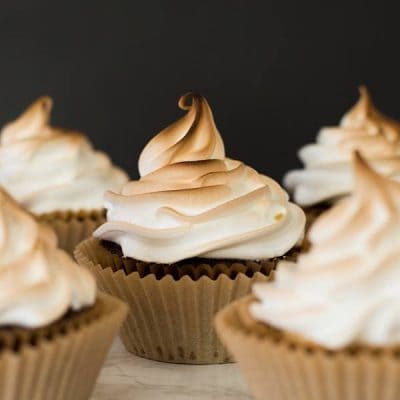 Cupcakes frosted with marshmallow frosting and toasted.