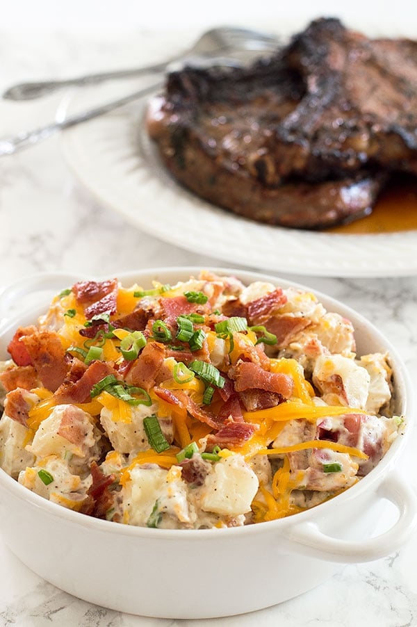 Creamy, cheesy loaded baked potato salad lightened up a bit with Greek yogurt (you'll never know it's there!). Recipe includes nutritional information. From BakingMischief.com