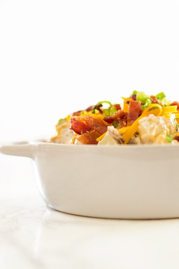 Creamy, cheesy loaded baked potato salad lightened up a bit with Greek yogurt (you'll never know it's there!). Recipe includes nutritional information. From BakingMischief.com