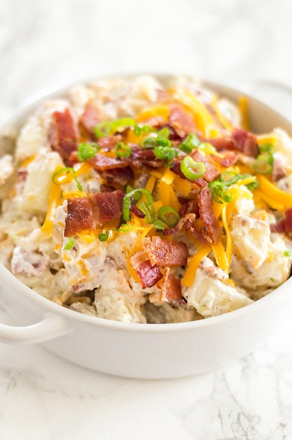 Creamy, cheesy loaded baked potato salad lightened up a bit with Greek yogurt (you'll never know it's there!). Recipe includes nutritional information. From BakingMischief.com