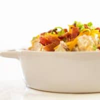 Creamy, cheesy baked potato salad lightened up a bit with Greek yogurt (you’ll never know it’s there!).