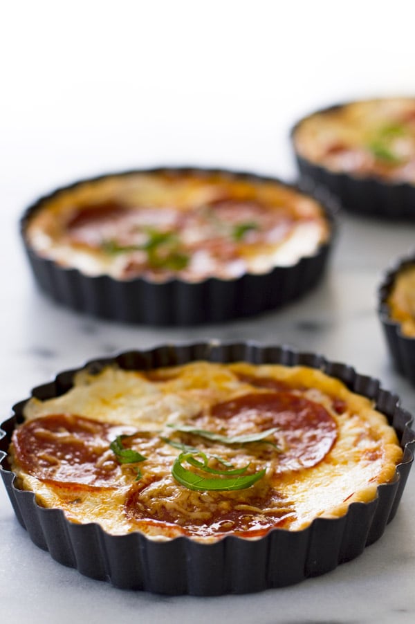 Pizza tarts in tart molds.