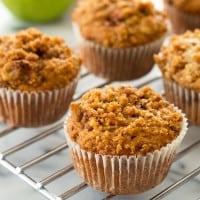 Apple crumb muffins on a cooling rack.