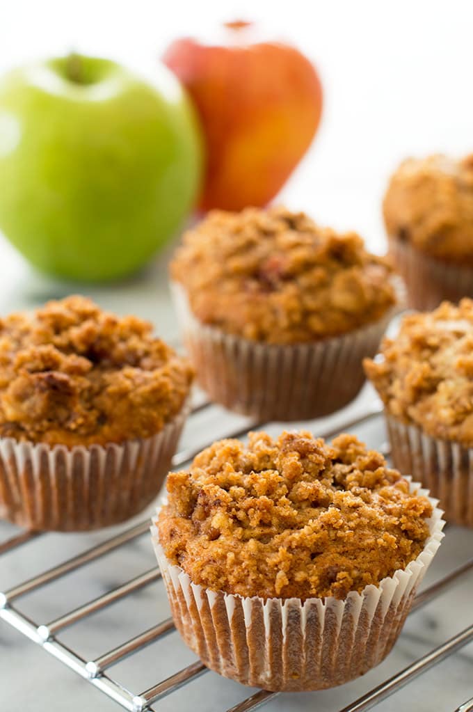 Apple crumb muffins on a cooling rack.