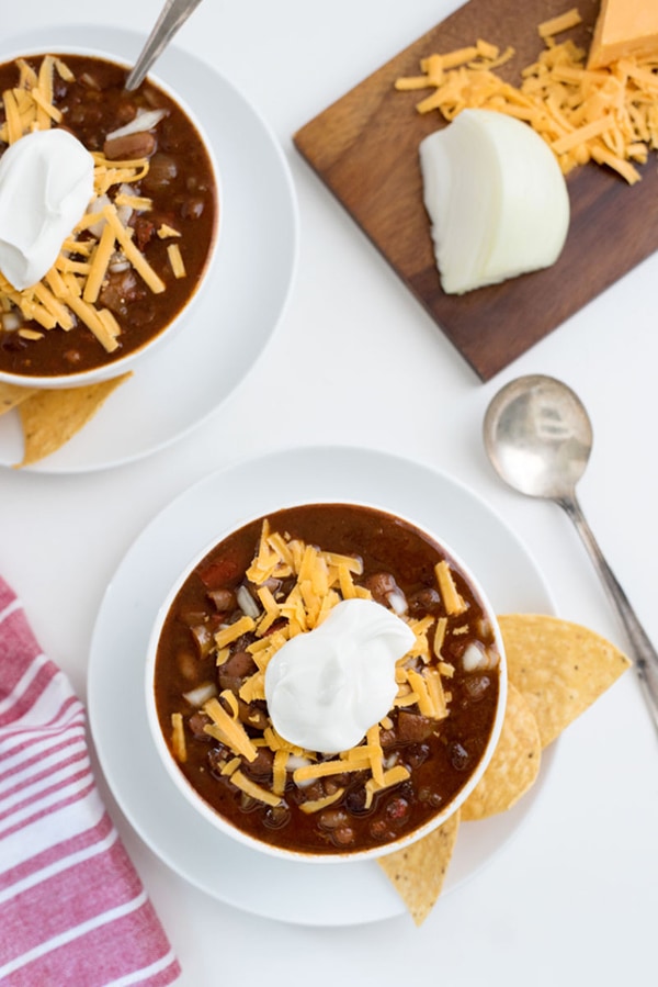 Vegetarian chili in white bowls.