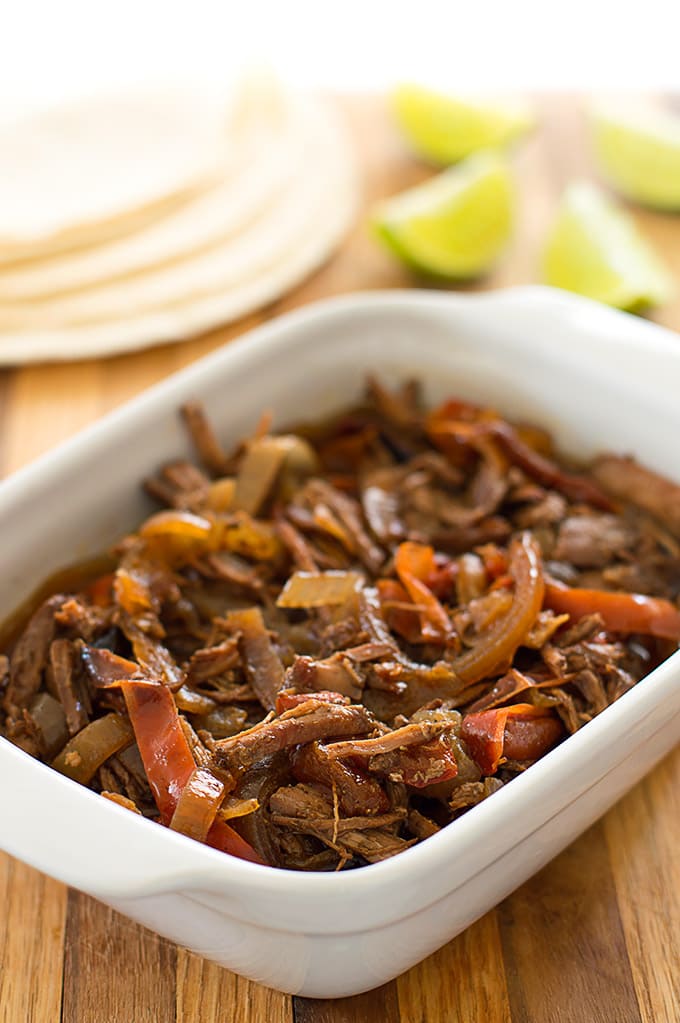 Slow cooker beef fajita mix in a white dish.