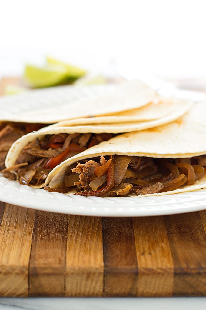 Beef fajitas on a white plate.