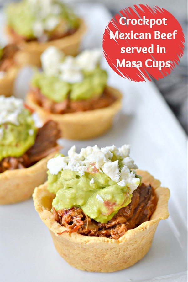 Beef in masa cups with guacamole on top.