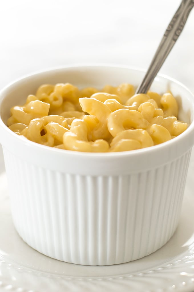 Single-serve homemade macaroni and cheese in a white bowl.