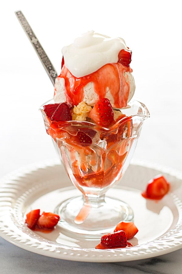 Strawberry shortcake sundae in a glass sundae cup.