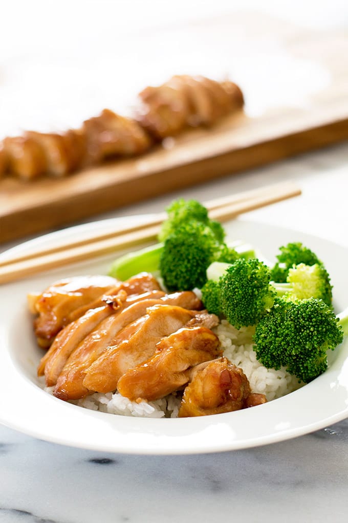 Teriyaki chicken in a bowl with rice and broccoli.