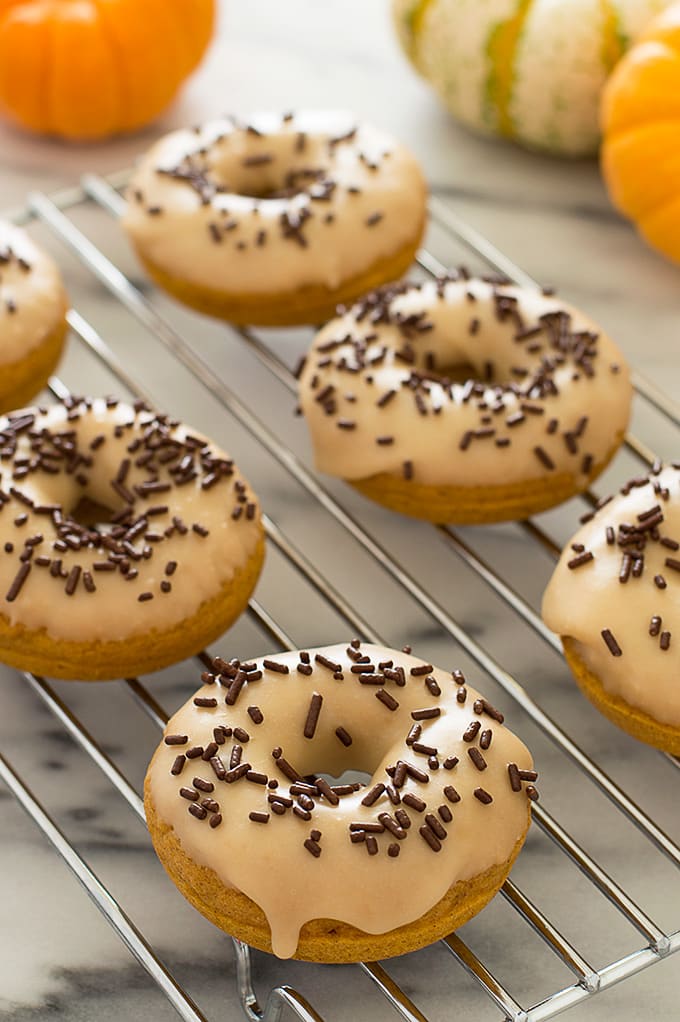 These Pumpkin Donuts with Maple Glaze are moist, lightly spiced, and delicious. Recipe includes nutritional information. From BakingMischief.com