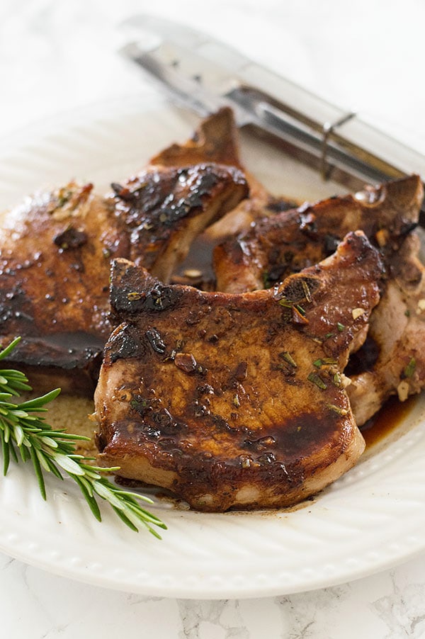 Rosemary pork chops on a plate.