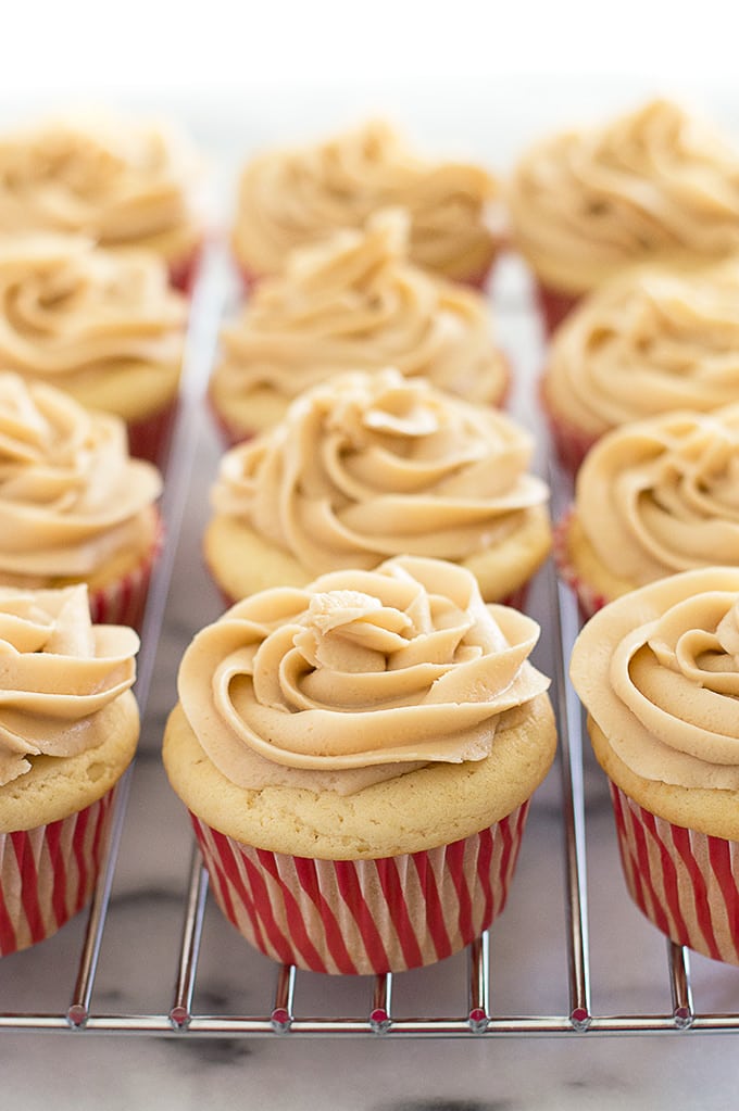 Apple pie cupcakes on a wire rack.