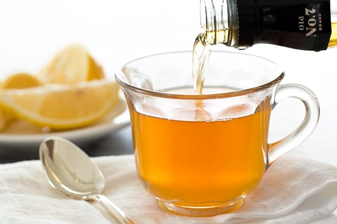 Whiskey being poured into a hot toddy.