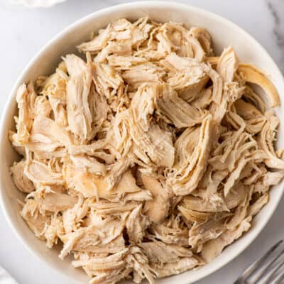 Shredded chicken in a white bowl.