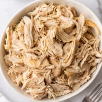 Shredded chicken in a white bowl.